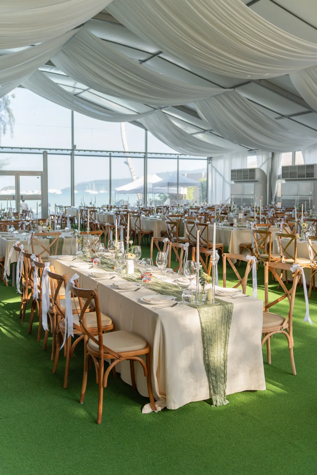 Wedding reception tables beneath a softly draped canopy in the garden