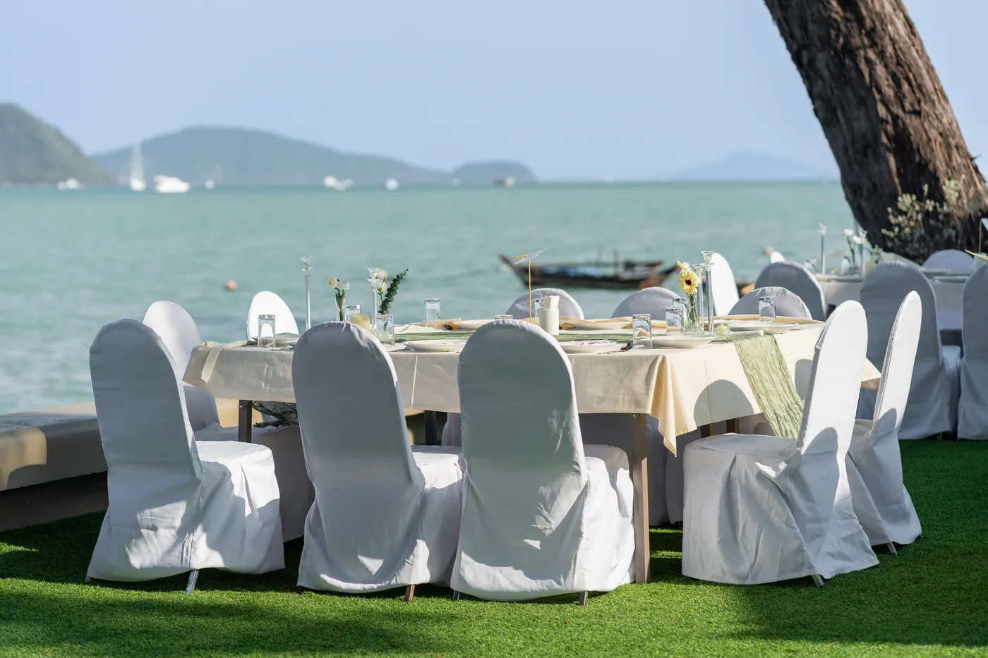 Wedding tables and white chairs on KEP’s lawn at the water’s edge